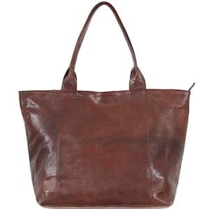 May include: A brown leather tote bag with two top handles. The bag has a zipper closure and a smooth, textured leather finish.