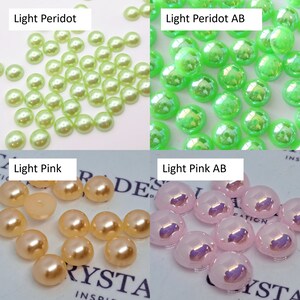 May include: Assortment of round, flat-backed, iridescent, decorative embellishments in four colors: light peridot, light peridot with an iridescent finish, light pink, and light pink with an iridescent finish.