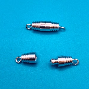 May include: Three silver-toned metal clasps for jewelry making. The clasps are designed to be used with necklaces, bracelets, or other jewelry projects.