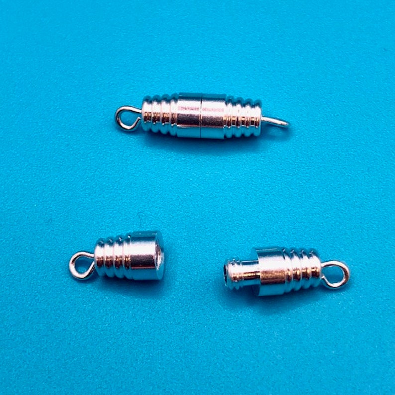 May include: Three silver-toned metal clasps for jewelry making. The clasps are designed to be used with necklaces, bracelets, or other jewelry projects.
