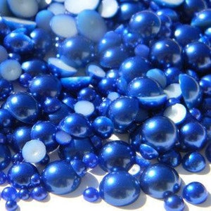 May include: A mix of blue pearl beads in various sizes. The beads are iridescent and have a smooth, glossy finish.