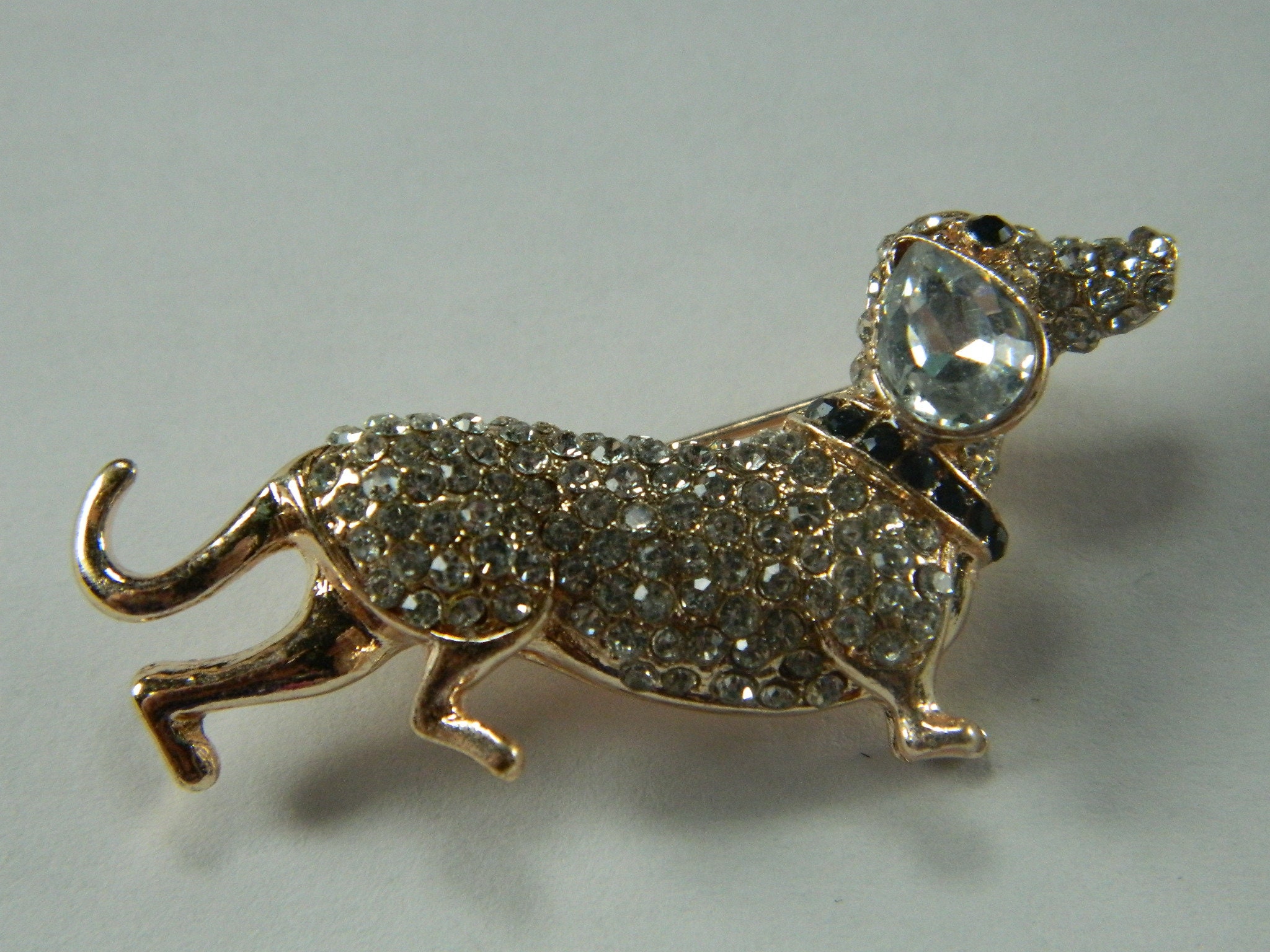 Dachshund dog pin, pewter look, pink eyes, very nice finish.