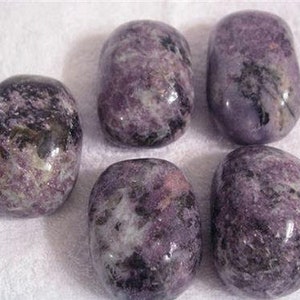 May include: Six smooth, polished purple and grey Lepidolite tumbled stones. The stones have a natural, irregular shape and a mottled appearance.