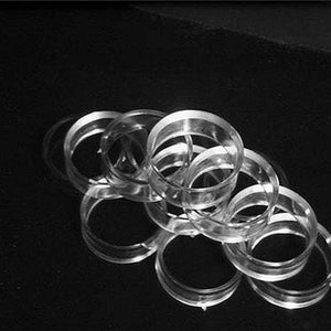 May include: A stack of clear plastic rings, possibly for a binder or other organizational purposes.