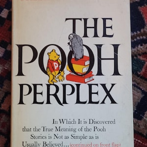 May include: A vintage book titled "The Pooh Perplex" by Frederick C. Crews. The cover features a cartoon illustration of Winnie the Pooh and a gray owl on top of a stack of books. The book's title is in large, bold letters.