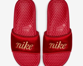 gold and red nike slides