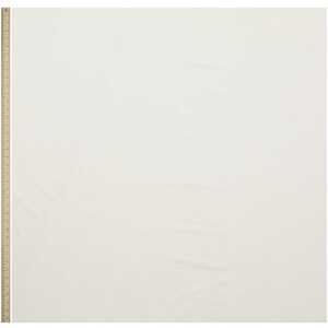 May include: A plain white fabric swatch with a wooden ruler in the left corner.