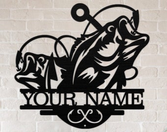 May include: Black metal wall art featuring a bass fish with a hook in its mouth. The fish is depicted with a realistic design and the words "YOUR NAME" are displayed below the fish.