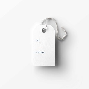 May include: A white gift tag with a string attached. The tag has the words "TO:" and "FROM:" printed on it.