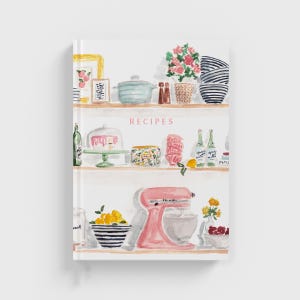May include: A watercolour illustration of a kitchen with shelves filled with various items, including a pink cake, a stand mixer, and bottles of wine. The text "RECIPES" is written in pink on the top shelf.