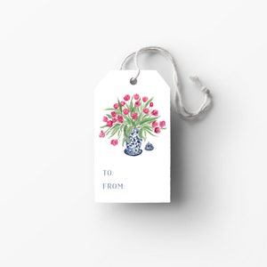 May include: A white gift tag with a blue and white porcelain vase filled with pink tulips. The tag has the words "TO:" and "FROM:" printed on it.