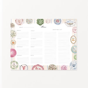 May include: A weekly menu planner notepad featuring a light blue striped background and a border of various colorful illustrated plates. The layout includes sections for Monday through Sunday, a notes section, and a shopping list column with the text Menu.