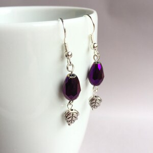Purple iridescent faceted glass bead with leaf charm earrings