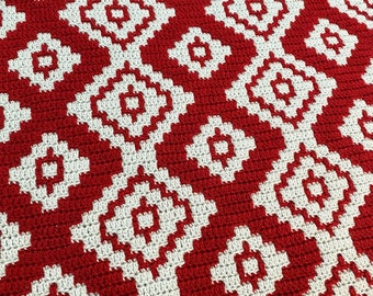 May include: Red and white crocheted blanket with a geometric diamond pattern.