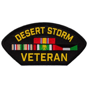 May include: Black patch with yellow text reading "DESERT STORM VETERAN." The patch features a series of colorful ribbons and a central emblem. The patch is shaped like a shield.