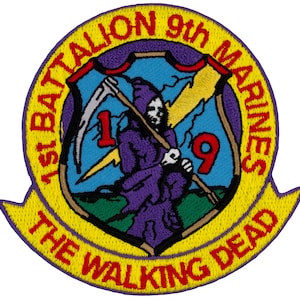 May include: A yellow and purple embroidered patch with the text "1st Battalion 9th Marines The Walking Dead". The patch features a purple grim reaper holding a scythe with the number "1" on the left and the number "9" on the right.