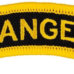 May include: Embroidered patch with the word "RANGER" in yellow letters on a black curved background. The patch has a yellow border with a stitched design. The patch is a military or tactical accessory.