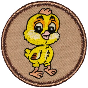 May include: A brown embroidered patch with a yellow chick with big eyes and a pink beak. The chick is standing on a brown background.