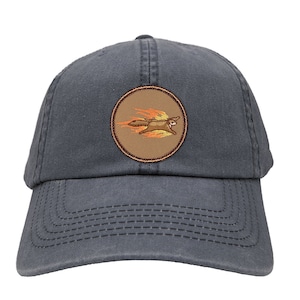 May include: A dark blue baseball cap with a brown patch featuring a cartoon squirrel on fire. The patch is circular and has a brown border.