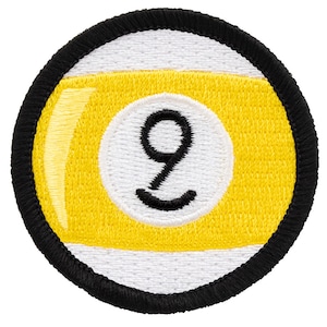 May include: Embroidered patch featuring a yellow and white nine-ball design. The number 9 is in black, centered on the yellow portion of the ball. The patch has a black border and white background.