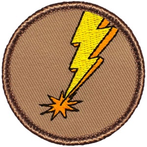 May include: A brown embroidered patch with a yellow lightning bolt and an orange starburst at the bottom.