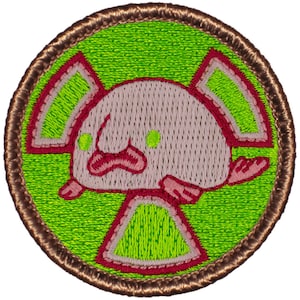 May include: A green, red, and white embroidered patch featuring a pink blobfish with green eyes. The blobfish is inside a red and white biohazard symbol.