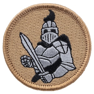 May include: A tan embroidered patch with a silver knight holding a sword. The knight is wearing armor and a helmet with a black plume.