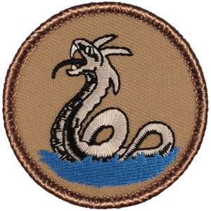 May include: A brown embroidered patch with a white and black serpent with a blue water background.