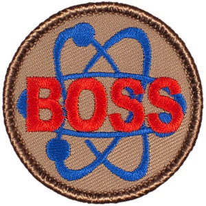 May include: A brown embroidered patch with a blue atom symbol and the word "BOSS" in red lettering.