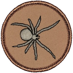May include: Embroidered patch featuring a detailed spider design. The spider is depicted in shades of gray, with a textured body and legs, set against a tan background. The patch has a brown stitched border, creating a circular shape. Ideal for jackets, bags, or other fabric items.