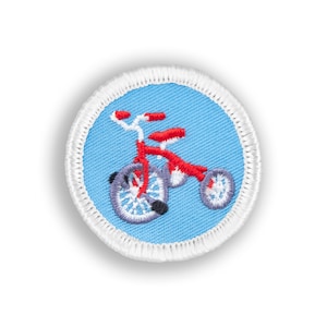 May include: A blue and white embroidered patch with a red tricycle on it.