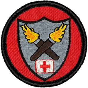 May include: A red and gray embroidered patch with a shield design. The shield features two crossed torches with flames, a red cross, and a black border.