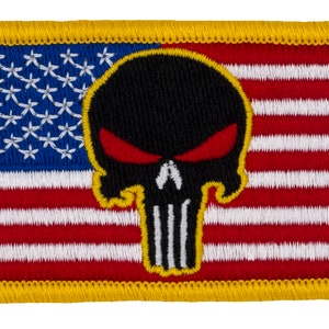 May include: A yellow-bordered patch with an American flag design. The flag has a black skull with red eyes in the center.