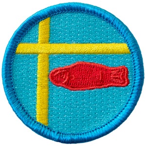 May include: A round patch with a light blue background, a yellow cross, and a red fish emblem. The patch has a blue border and is likely an embroidered design.