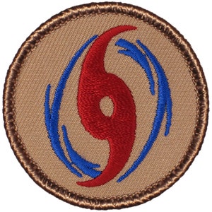 May include: A brown embroidered patch with a red and blue hurricane symbol. The symbol is a stylized hurricane with a red eye and blue wind bands.