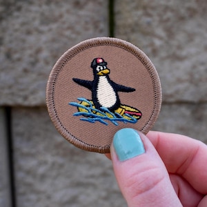 Surfing Penguin Patch (065) – 2 Inch Diameter Embroidered Patch