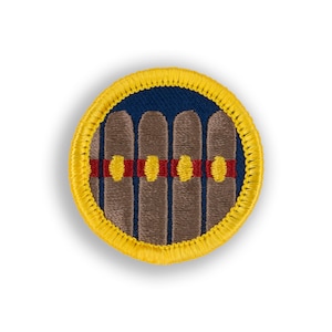 May include: A yellow embroidered patch with a blue background and four brown cigars with red and yellow bands.
