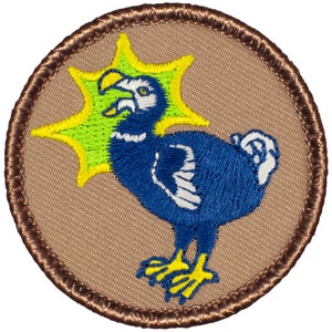 May include: A brown embroidered patch with a blue and white dodo bird with a yellow beak and feet. The dodo bird is surrounded by a yellow and green starburst.