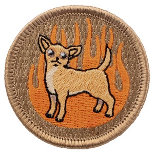 May include: A tan embroidered patch with a brown chihuahua standing in front of orange flames. The patch has a brown stitched border.