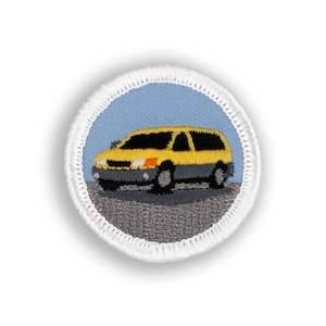 May include: A yellow embroidered patch with a white border depicting a yellow minivan on a gray road against a light blue background.