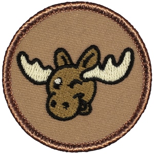 May include: A brown embroidered patch with a cartoon moose with large antlers. The moose is winking and has a brown and black outline.