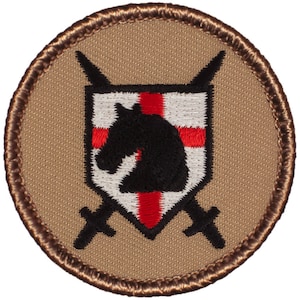 May include: A tan embroidered patch with a white shield with a red cross and a black horse's head. Two black swords are crossed behind the shield.