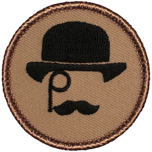 May include: A brown embroidered patch with a black bowler hat, monocle, and mustache.