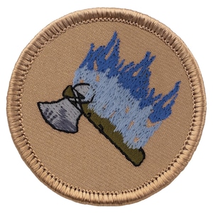 May include: A round, tan-colored patch with a blue and green embroidered image of a fire extinguisher with flames coming out of the top.