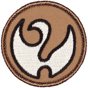 May include: A circular patch with a brown background and a white and black stylized design in the center. The design is a swirling, abstract shape. The patch has a brown border with stitched edges.