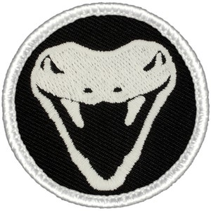 May include: White embroidered cobra snake head on a black circular patch with a white border.