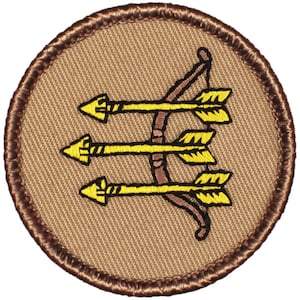 May include: A brown embroidered patch with a yellow bow and arrow design. The bow and arrow are in a circle with a brown border.
