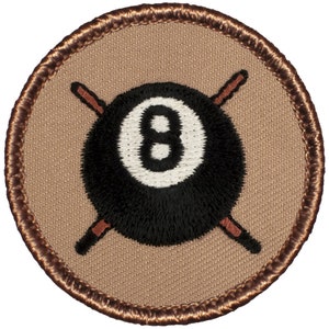 May include: A brown embroidered patch with a black 8-ball and crossed pool cues.