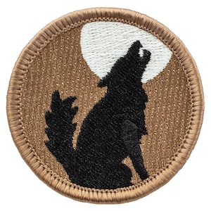 May include: A brown embroidered patch with a black wolf silhouette howling at a white moon.