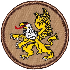 May include: A brown embroidered patch with a yellow griffin with white and red accents. The griffin is a mythical creature with the head and wings of an eagle and the body of a lion.